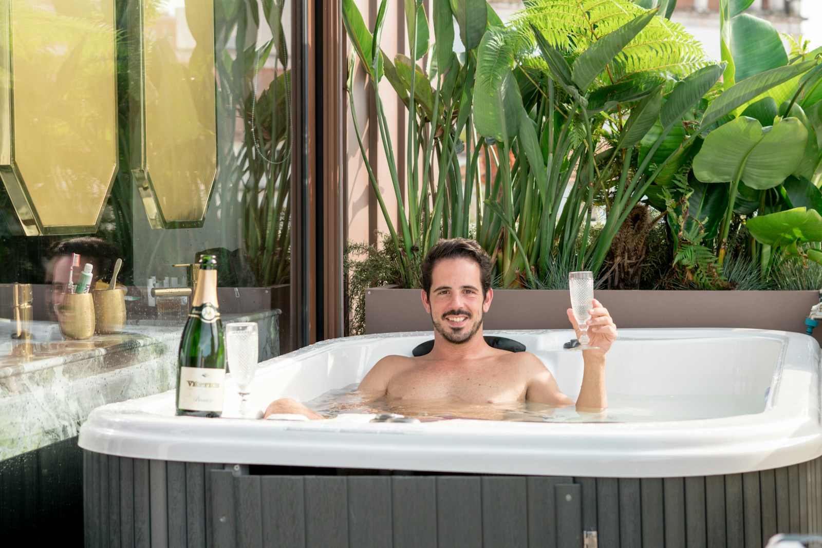 A man taking a picture of himself in a hot tub